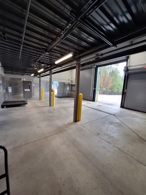 Indoor drive-up loading bay with open garage doors
